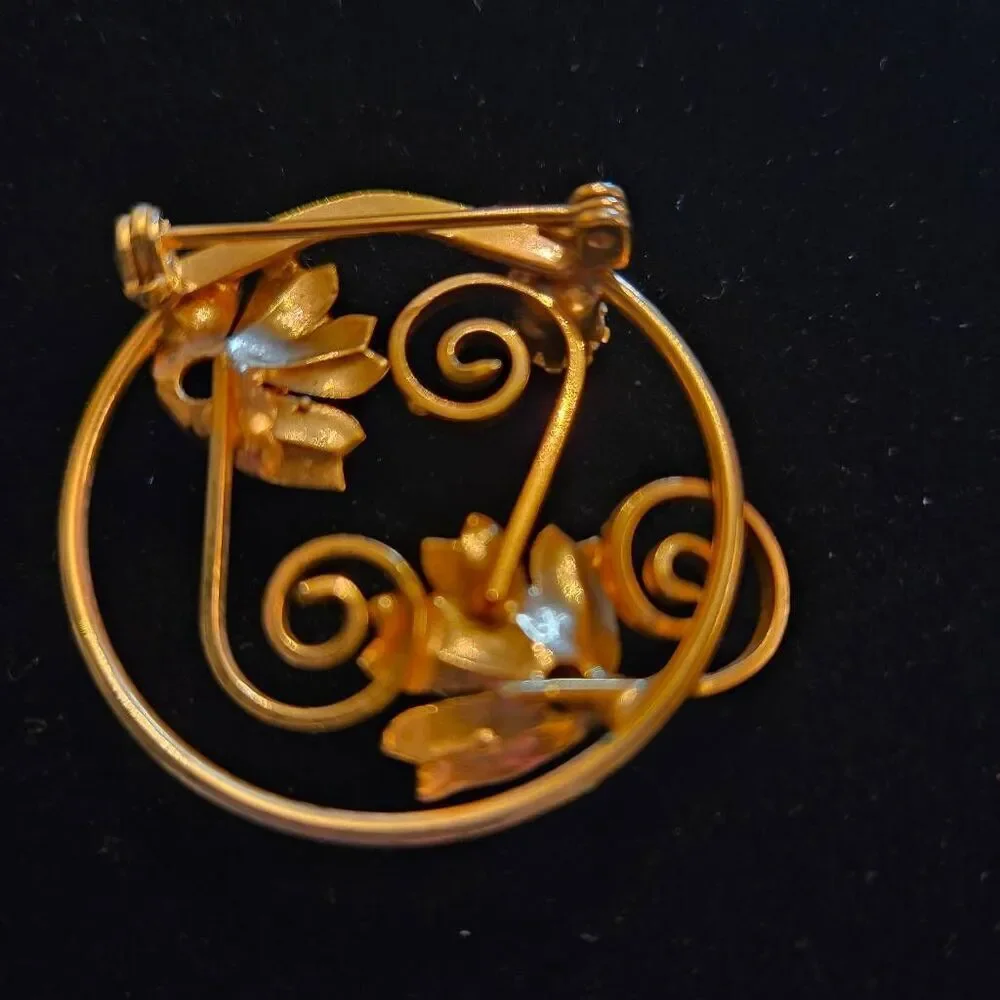 Vintage Gold Tone Floral Circle Brooch Featuring 3 purple rhinestones